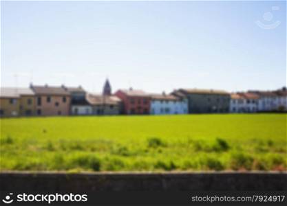Houses and grass field in blurred background, horizontal image