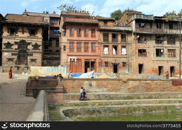 Houses and pool with green water in Bhaktapur, Nepal