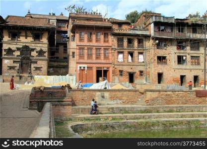 Houses and pool with green water in Bhaktapur, Nepal