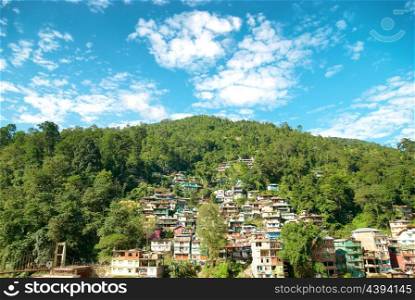 Houses in a town on green hill. India, Sikkim, Gangtok