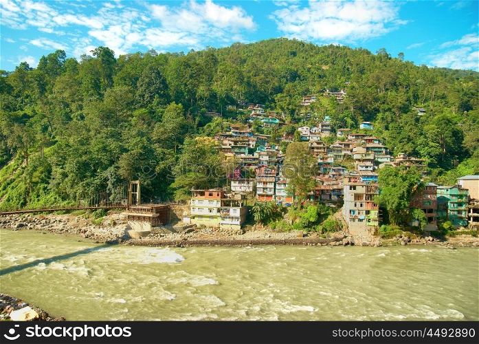 Houses in a town on river. India, Sikkim, Gangtok