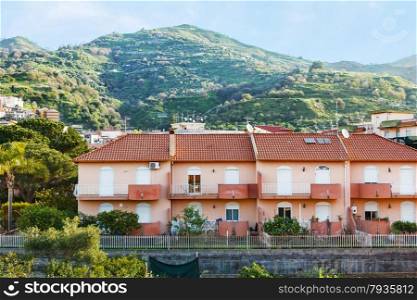 houses in town Gaggi in Sicily on green hills, Italy in spring day
