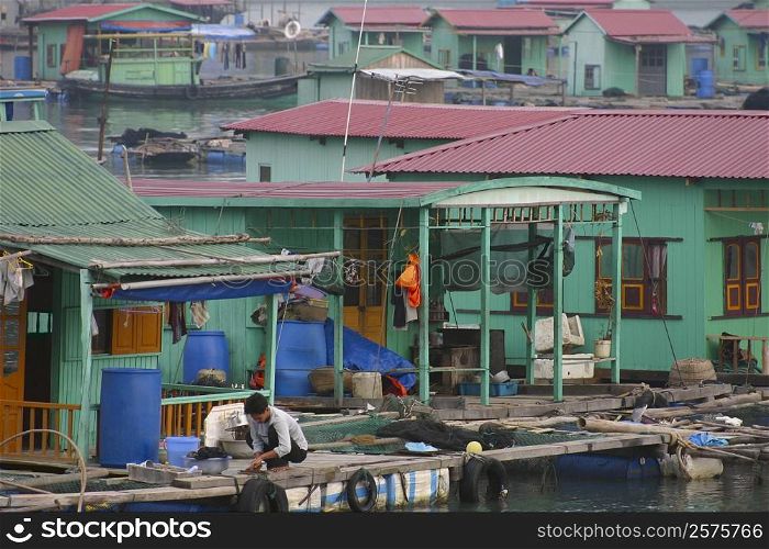 Houses on stilts in a village, Halong Bay, Vietnam