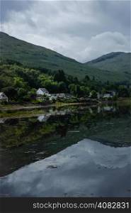 Houses reflected in loch