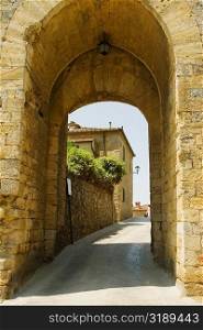 Houses viewed through an archway, Porta Franca, Monteriggioni, Siena Province, Tuscany, Italy