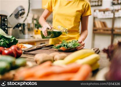 Housewife cooking on the kitchen, healthy eco food preparation. Vegetarian diet, fresh vegetables and fruits on wooden table