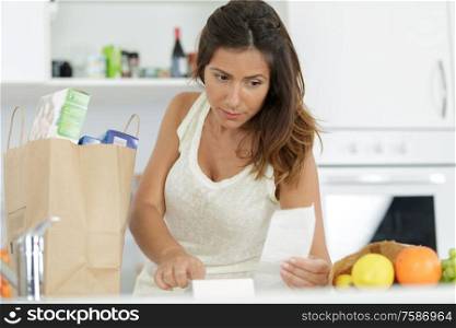 housewife examines check after shopping