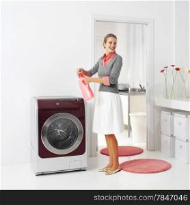 housewife keeps detergent near the washing machine in laundry room