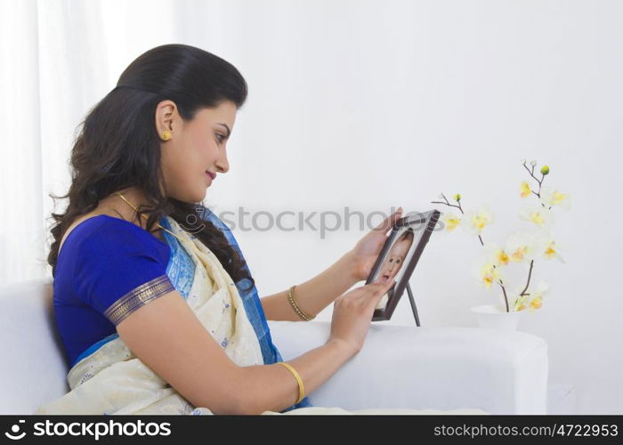 Housewife looking at a baby photograph