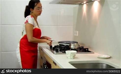Housewife making tea in the kitchen