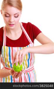 Housewife or chef in colorful kitchen using apple timer eggtimer isolated studio shot