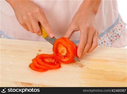 housewife preparing tomato .Studio, white background.