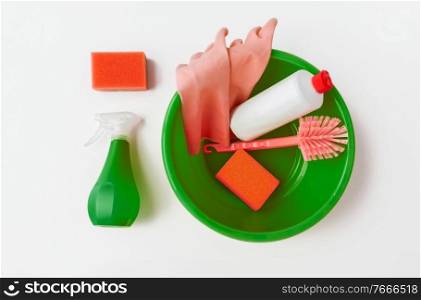 housework and housekeeping concept - plastic basin with cleaning tools on white background. basin with cleaning tools on white background