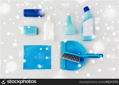 housework, housekeeping and household concept - cleaning stuff on white background over snow. cleaning stuff on white background