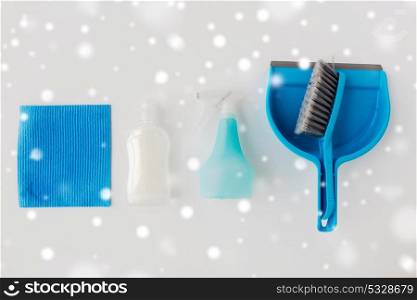 housework, housekeeping and household concept - cleaning stuff on white background over snow. cleaning stuff on white background