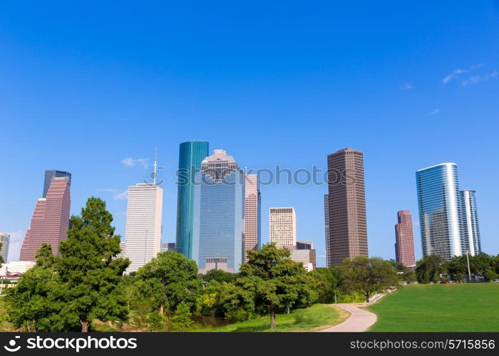 Houston skyline sunny day with park turf under blue sky at Texas USA