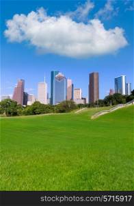 Houston skyline sunny day with park turf under blue sky at Texas USA