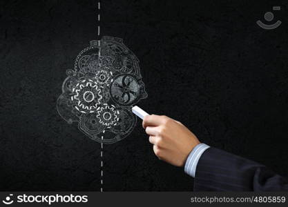 How it works. Close up of hand drawing gears mechanism with chalk