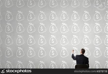 How to increase your income. Rear view of businessman drawing with marker money earning concept