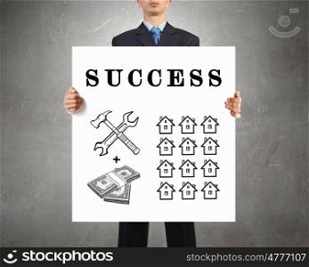 How to inlarge your income. Businessman holding banner with drawn money earning concept
