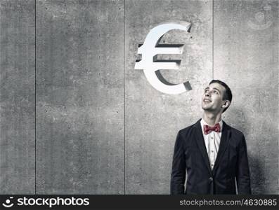 How to make your income grow. Portrait of young man looking above his head on euro sign
