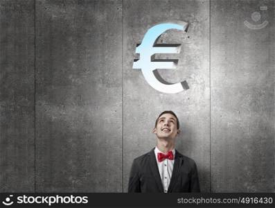 How to make your income grow. Portrait of young man looking above his head on euro sign