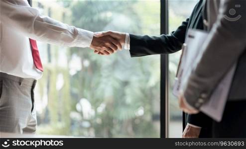 HR manager woman shaking hand with male candidate after successful job interview in office.