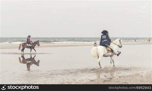 Hua hin city in Thailand 27/04/2016, Tourist testing ride to horse on beach at Hua Hin beach.