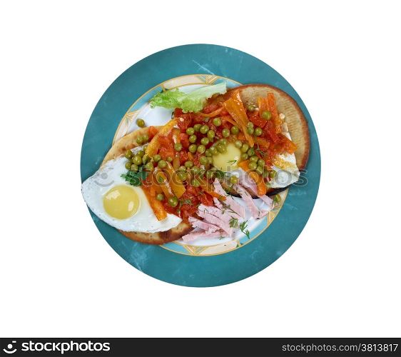 Huevos Motulenos - breakfast food in the town of Motul (Yucatan) dish is made with eggs on tortillas , ham, peas, plantains, and salsa picante
