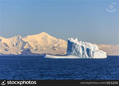 Huge blue iceberg drifting across the sea at Lemaire Channel, Antarctica