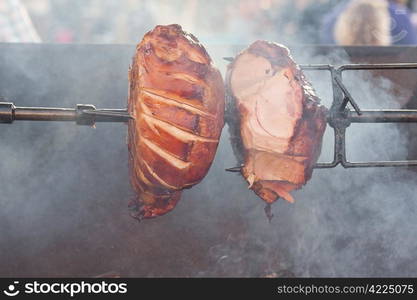 huge chunks of pork roasting on a spit