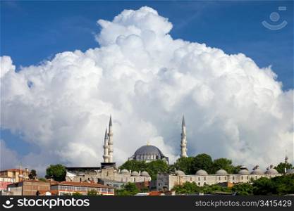 Huge cumulonimbus cloud over the Suleymaniye Mosque, an Ottoman imperial mosque historic landmark in Istanbul, Turkey.