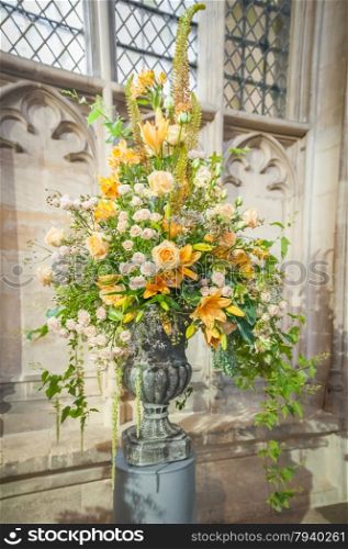 huge floral wedding bouquet arrangement on display in a church