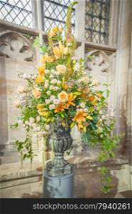 huge floral wedding bouquet arrangement on display in a church