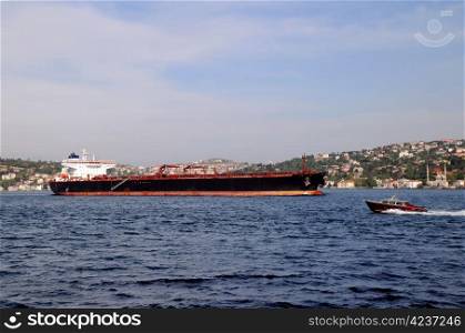 Huge oil tanker and small motor boat in the Bosphorus