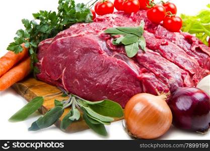 huge red meat chunk with vegetables isolated over white background