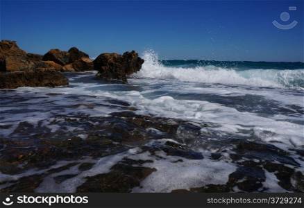 Huge rocks on the coast of the storm sea