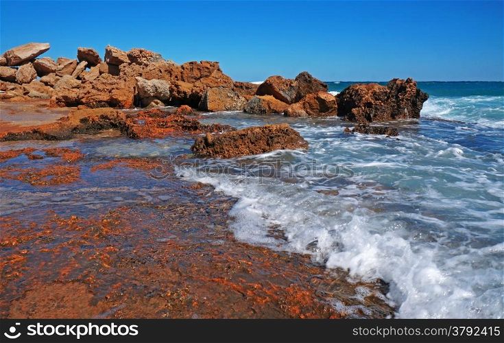 Huge rocks on the coast of the storm sea