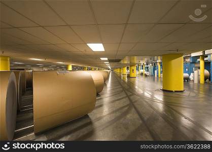 Huge rolls of paper in newspaper factory