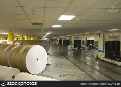 Huge rolls of paper in newspaper factory