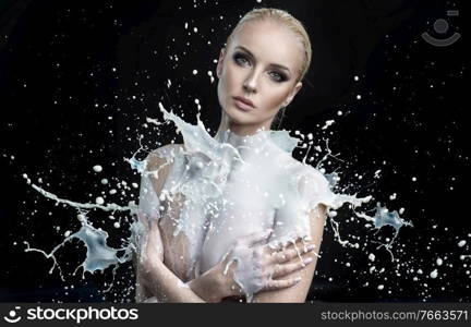 Huge splash of white paint on a young female body