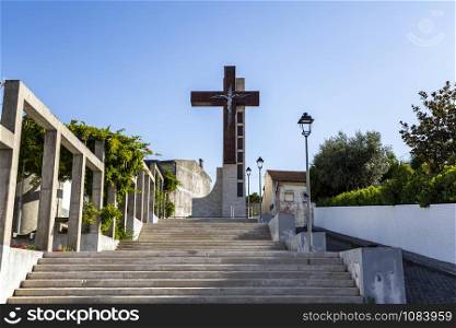 Huge steel cross on top of the staircase in Vila Nova de Poiares, Coimbra, Portugal