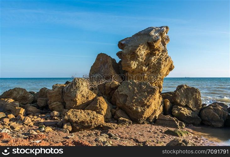 Huge stone by the sea on a Sunny autumn day on the seashore near the village of Fontanka, Odessa region, Ukraine. Huge stone by the sea