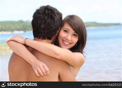 Hugging boyfriend at beach
