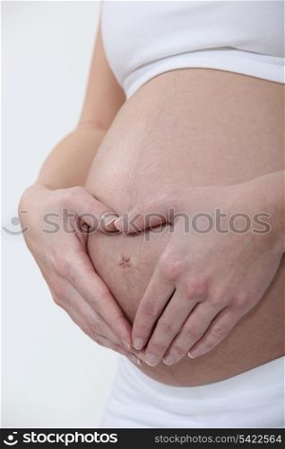 Hugging her pregnant belly