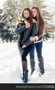 Hugging the best girlfriends in the winter in the snow