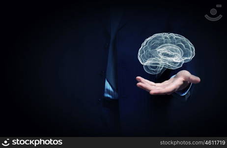 Human brain. Close up of businessman hand holding brain in palm