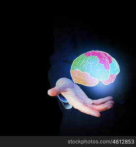 Human brain. Close up of businessman hand holding brain in palm