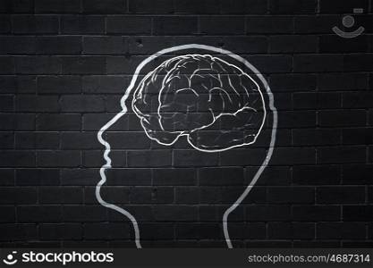 Human brain. Human hand drawing brain on black chalkboard