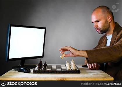 human chess player against computer on gray background